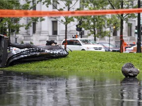 The statue of Sir John A. Macdonald lies in two pieces at the base of the monument from which it was pulled during demonstration by the Coalition for BIPOC Liberation in Montreal on Saturday, Aug. 29, 2020.