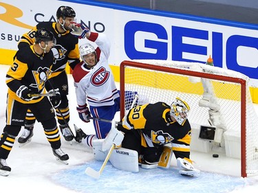 Jesperi Kotkaniemi #15 of the Montreal Canadiens celebrates his goal as Matt Murray #30 of the Pittsburgh Penguins looks at the puck in Game One of the Eastern Conference Qualification Round prior to the 2020 NHL Stanley Cup Playoffs at Scotiabank Arena on August 01, 2020 in Toronto, Ontario. Jack Johnson #3 and Zach Aston-Reese #46 of the Pittsburgh Penguins look on.