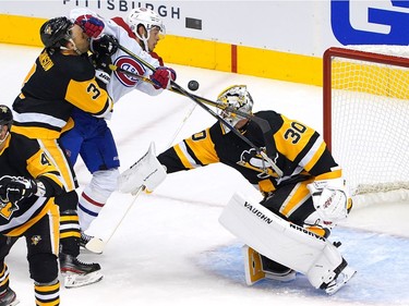 Matt Murray #30 of the Pittsburgh Penguins is unable to stop a shot from Jesperi Kotkaniemi #15 of the Montreal Canadiens as Jack Johnson #3 of the Penguins defends in the first period in Game One of the Eastern Conference Qualification Round prior to the 2020 NHL Stanley Cup Playoffs at Scotiabank Arena on August 01, 2020 in Toronto, Ontario.