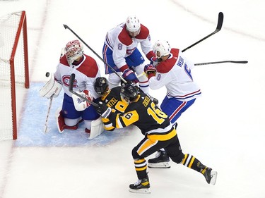 Carey Price #31 of the Montreal Canadiens watches as a shot by Jason Zucker #16 of the Pittsburgh Penguins goes past but not in the net while teammates Ben Chiarot #8 and Shea Weber #6 shove Jake Guentzel #59 of the Pittsburgh Penguins during Game One of the Eastern Conference Qualification Round prior to the 2020 NHL Stanley Cup Playoffs at Scotiabank Arena on August 01, 2020 in Toronto, Ontario.