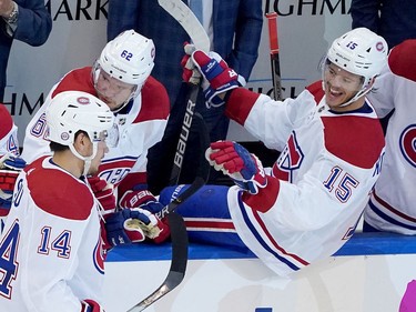Nick Suzuki #14 of the Montreal Canadiens is congratulated by teammate Jesperi Kotkaniemi #15 after Suzuki scored a goal in the second period against the Pittsburgh Penguins during Game One of the Eastern Conference Qualification Round prior to the 2020 NHL Stanley Cup Playoffs at Scotiabank Arena on Aug. 1, 2020 in Toronto.