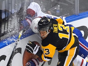 Ben Chiarot #8 of the Montreal Canadiens is hit by Brandon Tanev #13 of the Pittsburgh Penguins as they both go after the puck in the third period during Game One of the Eastern Conference Qualification Round prior to the 2020 NHL Stanley Cup Playoffs at Scotiabank Arena on August 01, 2020 in Toronto, Ontario.