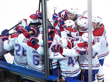The Montreal Canadiens surround teammate Jeff Petry #26 after he scored the game winning goal in overtime against the Pittsburgh Penguins during Game One of the Eastern Conference Qualification Round prior to the 2020 NHL Stanley Cup Playoffs at Scotiabank Arena on August 01, 2020 in Toronto, Ontario.
