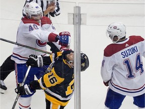 Joel Armia of the Montreal Canadiens, left, and Jason Zucker of the Pittsburgh Penguins mix it up in Game 2 of the Eastern Conference Qualification Round at Scotiabank Arena on Aug. 3, 2020, in Toronto.