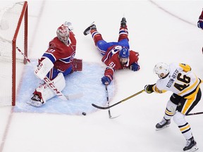 Canadiens' Carey Price stymies Penguins' Zach Aston-Reese after defenceman Xavier Ouellet made a diving attempt to alter the shot.