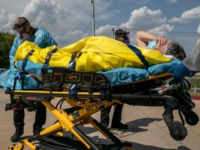 Medics with Austin-Travis County EMS transport a nursing home resident with coronavirus symptoms on Aug. 3, 2020, in Austin, Tex. Texas has had the third-highest number of COVID-19 cases in the United States, following Florida and California.