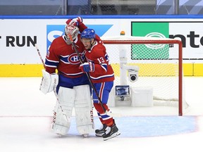Max Domi congratulates goalie Carey Price after the Canadiens beat the Pittsburgh Penguins 2-0 at Toronto’s Scotiabank Arena in Game 4 to win their best-of-five qualifying series 4-1.