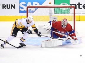 Canadiens goalie Carey Price makes a save while Penguins star Evegeni Malkin lurks around the net during Game 4 of the team's qualification-round series last week. Price was outstanding, posting a 1.67 goals-against average and a .947 save percentage in the series.
