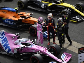 Third placed qualifier Nico Hulkenberg of Germany and Racing Point celebrates with fifth place qualifier Daniel Ricciardo of Australia and Renault Sport F1 in parc ferme during qualifying for the F1 70th Anniversary Grand Prix at Silverstone Aug. 8, 2020 in Northampton, England.
