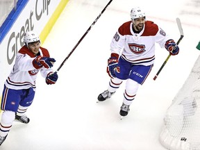 The Canadiens’ Jake Evans (left) and Alex Belzile celebrate after setting up linemate Joel Armia for a second-period goal in a 5-0 win over the Philadelphia Flyers in Game 2 of the first round NHL playoff series at Toronto’s Scotiabank Arena.