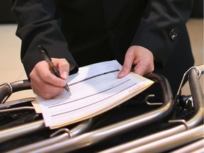 A man fills out a job application form: A report released by the Quebec government language law enforcement agency, known as the OQLF, focuses on the recruitment practices of Quebec employers with respect to language skills.