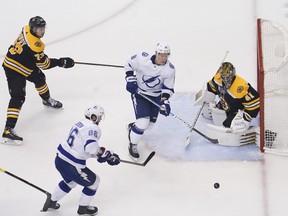 Boston Bruins goaltender Jaroslav Halak, right, defends the net against Tampa Bay Lightning right wing Nikita Kucherov, bottom left, and left wing Ondrej Palat, second from right, during the third period in Game 4 of the second round of the 2020 Stanley Cup Playoffs at Scotiabank Arena in Toronto  on Saturday, Aug. 29, 2020.