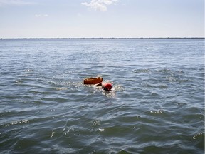 Ariane Bijould swims, with a floatation device in tow, along the shore of the Saint-Lawrence River in Montreal, on Friday, July 24, 2020. (Allen McInnis / MONTREAL GAZETTE)