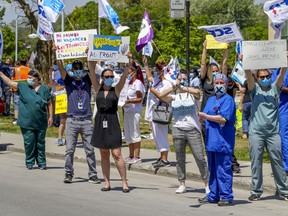 Health care workers demonstrate outside Maisonneuve-Rosemont Hospital in Montreal Wednesday May 27, 2020.