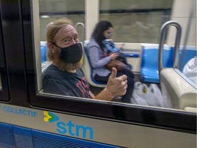 Mask-wearing transit user gives a photographer the thumbs up at the Guy-Concordia Metro station on Monday, August 24, 2020.
