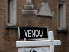 Sold signs on residential real estate placards in Westmount.