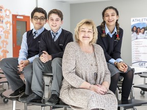 Janice Ewanyshyn, middle school co-ordinator, is shown with a trio of students. Through elementary, middle school, high school and Grade 12, each Kells Academy student is met with a welcoming, supportive and inclusive academic environment.