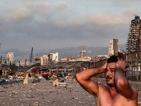 A man reacts at the scene of an explosion at the port in Lebanon's capital Beirut on Tuesday.