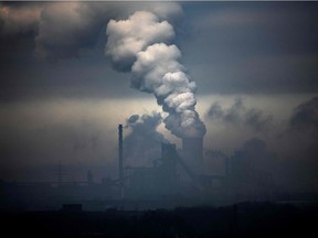 This file photo taken on Jan. 23, 2020, shows vapour clouds emerging from plant of German industrial conglomerate ThyssenKrupp (foreground) and a coal-fired power station in Duisburg, western Germany. - The unprecedented fall in greenhouse gas emissions from lockdowns during the pandemic will do "nothing" to slow climate change without a lasting switch from fossil fuels, an international team of researchers said Aug. 7, 2020.