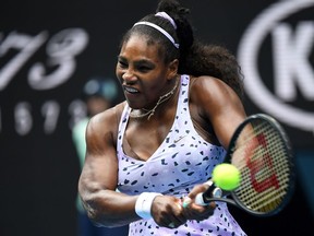 In this file photo taken on January 24, 2020 Serena Williams of the US hits a return against China's Wang Qiang during their women's singles match on day five of the Australian Open tennis tournament in Melbourne. - A rusty Serena Williams made a winning return from her six-month coronavirus hiatus on August 11, 2020, defeating lowly ranked Bernarda Pera in three sets to advance to the second round of the WTA Top Seed Open tournament in Kentucky.