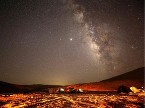 A Perseid meteor streaks across the sky above a camping site at the Negev desert near the city of Mitzpe Ramon on August 11, 2020 during the Perseids meteor shower.