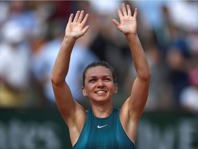 In this file photo taken on June 9, 2018 Romania's Simona Halep celebrates after victory over Sloane Stephens of the US during their women's singles final match on day fourteen of The Roland Garros 2018 French Open tennis tournament in Paris. - World number two Simona Halep will not take part in the US Open, she said on her Twitter account on August 17, 2020. (Photo by CHRISTOPHE SIMON / AFP)