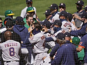 Players from the Houston Astros and Oakland Athletics get into a shoving match after Ramon Laureano of the Athletics was hit by a pitch and charged into the Astros dugout at RingCentral Coliseum on August 9, 2020 in Oakland.