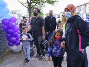 Parents accompany their children back to school at the Philippe-Labarre Elementary School in Montreal, on Thursday, Aug. 27, 2020.