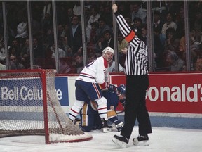 Referee Ron Hoggarth calls a penalty on Canadiens forward Chris Nilan at the Montreal Forum during the 1987-88 season.
