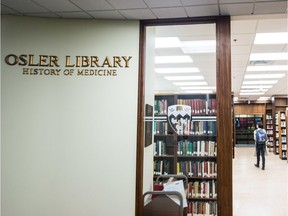 A woman walks through the Osler Library of History of Medicine at the McGill University Faculty of Medicine McIntyre Medical Building in Montreal in 2013. The library's collection has been temporarily relocated in the wake of a 2018 fire.