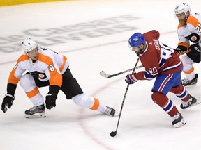Montreal Canadiens left wing Tomas Tatar (90) skates the puck against Philadelphia Flyers defenseman Robert Hagg (8) and center Claude Giroux (28) during the third period in game six of the first round of the 2020 Stanley Cup Playoffs at Scotiabank Arena.