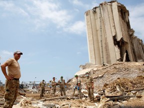 Soldiers stand at the devastated site of the explosion at the port of Beirut, Lebanon August 6, 2020. Thibault Camus/Pool via REUTERS