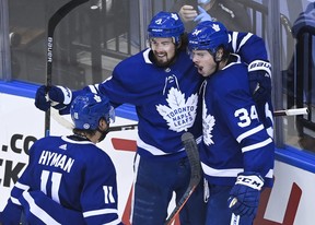 Maple Leafs centre Auston Matthews (34) celebrates his goal with teammates Justin Holl (3) and Zach Hyman after scoring against the Columbus Blue Jackets in the second period of their NHL Eastern Conference play-in game on Tuesday.