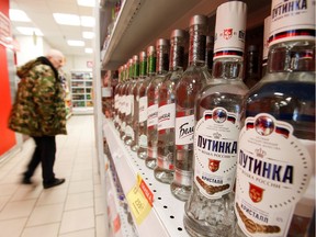 A customer walks past shelves with bottles of vodka in a supermarket amid the coronavirus disease (COVID-19) pandemic in Moscow, Russia April 8, 2020.