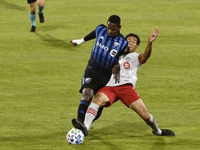 Montreal Impact midfielder Romell Quioto (30) plays the ball and Toronto FC midfielder Nick DeLeon (18) defends during the first half at Stade Saputo on Friday, Aug. 28, 2020.
