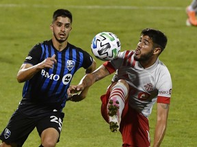 Toronto FC midfielder Alejandro Pozuelo (10) plays the ball and Montreal Impact midfielder Emanuel Maciel (25) defends during the second half at Stade Saputo on Aug. 28.