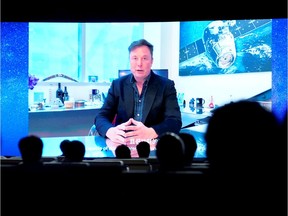 Tesla Inc Chief Executive Officer Elon Musk is seen on a screen during a video message at the opening ceremony of the World Artificial Intelligence Conference (WAIC) in Shanghai, China, on July 9, 2020.