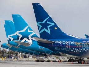 MONTREAL, QUE.: MAY 7, 2020 -- Idle Air Transat jets sit parked at Montréal-Pierre Elliott International Airport in Montreal, Thursday, May 7, 2020. (John Mahoney / MONTREAL GAZETTE)