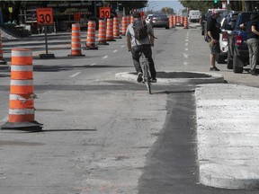 Cyclist tries out the new bike lane on St-Denis St. Aug. 28, 2020.