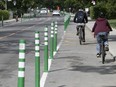 Cyclists and cars take notice of the newly installed bollards on a bike path on Terrebonne St. near Cavendish Blvd. on Friday Sept. 4, 2020.