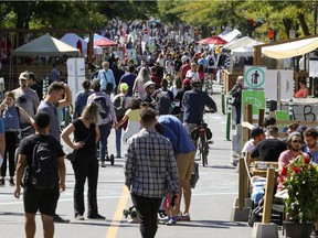 People fill the street at the Mont-Royal Ave. sidewalk sale in Montreal on Sunday, Sept. 6, 2020.