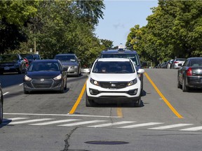 Cars mistakenly use the painted median up the middle of Cavendish Rd. in Montreal as a turning lane on Sunday, Sept. 6, 2020.