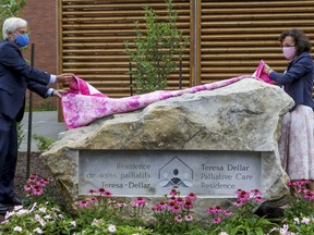 West Island Palliative Care Residence co-founder and former MNA Russell Williams and Dale Weil, executive director, unveil a monument renaming residence the Teresa Dellar Palliative Care Residence in Kirkland.