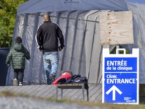 A man and a boy enter a COVID-19 testing centre in Beaconsfield Sept. 17, 2020.