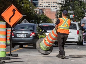 Cones are moved about on Sainte-Catherine West in Montreal on Sept. 18, 2020.