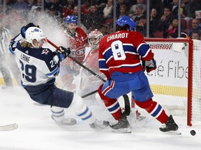 Canadiens defenceman Ben Chiarot prevents Winnipeg Jets right-winger Patrik Laine from getting to the puck as goaltender Carey Price looks on in Montreal on Jan. 6, 2020.