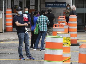 People wait in line for COVID-19 testing at Hotel Dieu hospital on Monday Sept. 28, 2020.