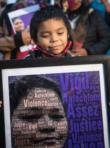Joyce Echaquan, a 37-year-old Atikamekw woman died at Joliette hospital after she posted a video of slurs said by staff right before her death. A vigil was held in her honour in Saint-Charles-Borromee Sept. 29, 2020. This is 5-year-old Luca Dube with a picture of his mother at the vigil.