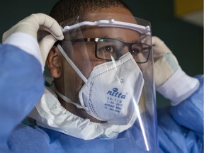 Venezuelan physician Yohn Segovia puts on a face shield before starting his medical rounds for COVID-19 positive patients at the Hotel "Milenio" in Caracas, Venezuela, Aug. 30, 2020. For those who work at close quarters with sick patients, the general consensus is that it is better to be safe than sorry, Christopher Labos writes.