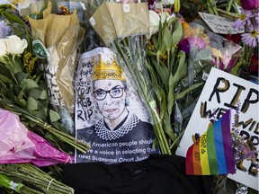 Mourners place flowers, messages and mementos at a makeshift memorial in honour of Supreme Court Justice Ruth Bader Ginsburg in front of the U.S. Supreme Court on September 19, 2020 in Washington, D.C.